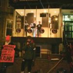 Tasia Edmonds speaks at a picket outside of the Boston University Insomnia Cookies Location. The manager that suspended her and a guard hired from Securitas glower down from the window above. Photo by Fellow Worker D